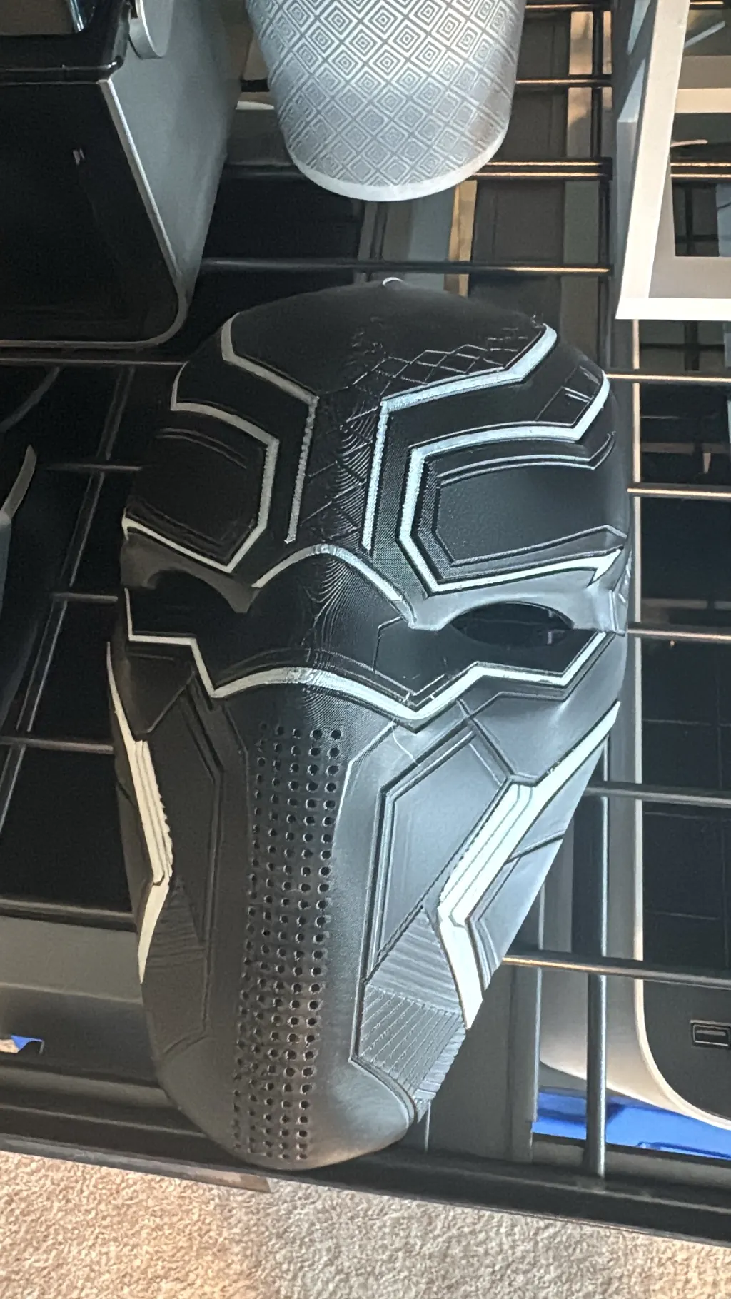 Black and gray panther superhero helmet showing layer detail